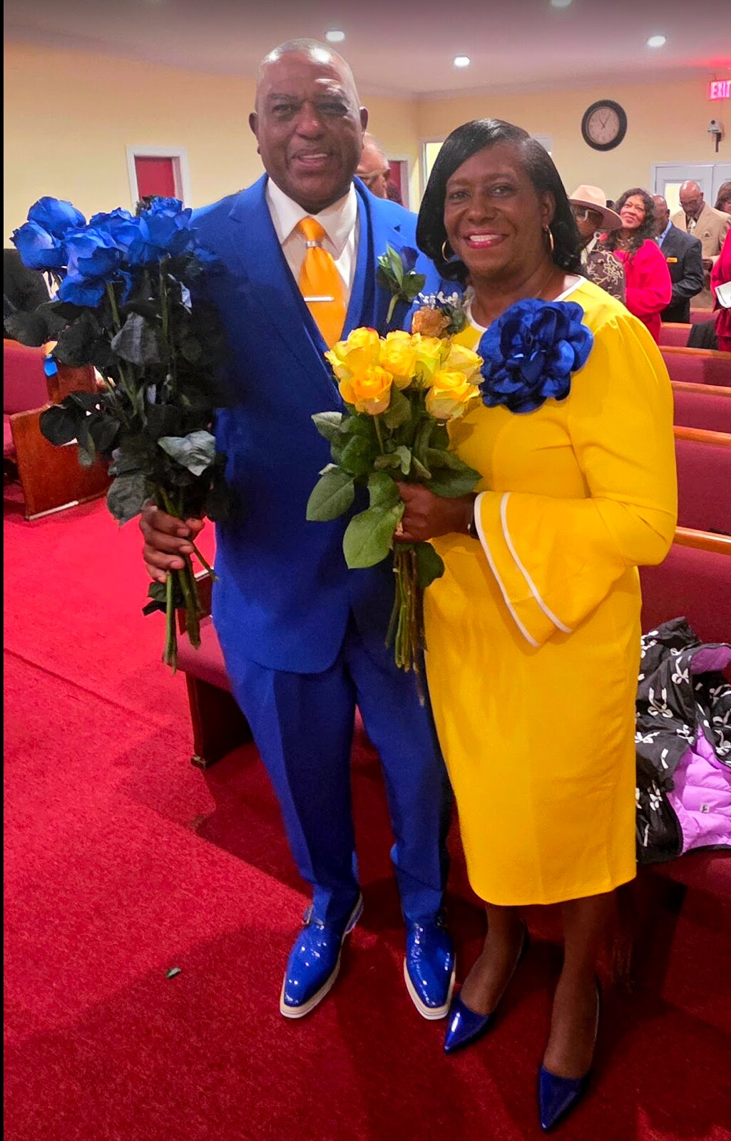 Pastor Gary Moore and First Lady Mildred Moore standing together in the Daisy Chapel sanctuary